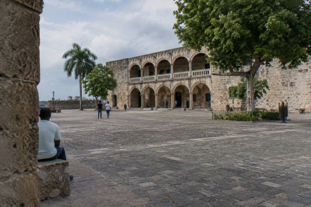 Pastel colored colonial buildings on a narrow pedestrian street in Santo Domingo